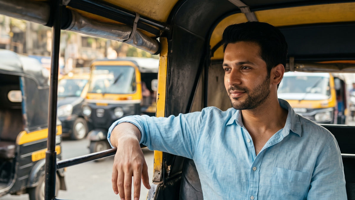 Illustration of a young Indian man in the back seat of an auto-rickshaw in afternoon traffic, a light shine on his forehead